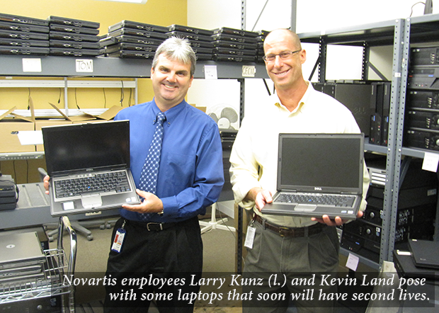 Image Novartis employees Larry Kunz (l.) and Kevin Land pose with some laptops that soon will have second lives.