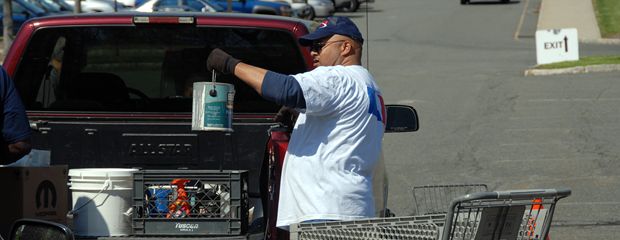 image of examining a paint can taken from a pickup truck.