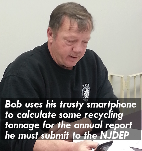 Bob uses his trusty smartphone to calculate some recycling tonnage for the annual report he must submit to the State of New Jersey.