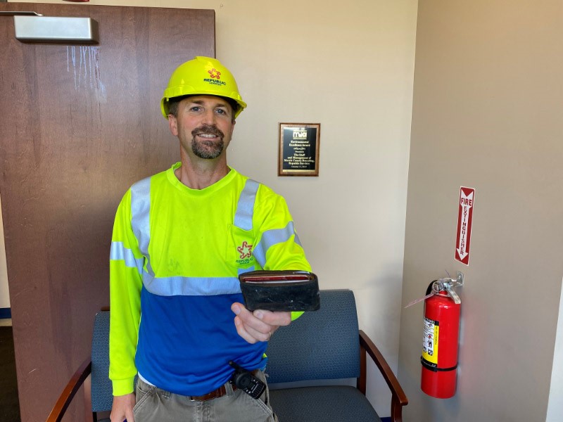 image of Eric Gabrielson holding a found wallet