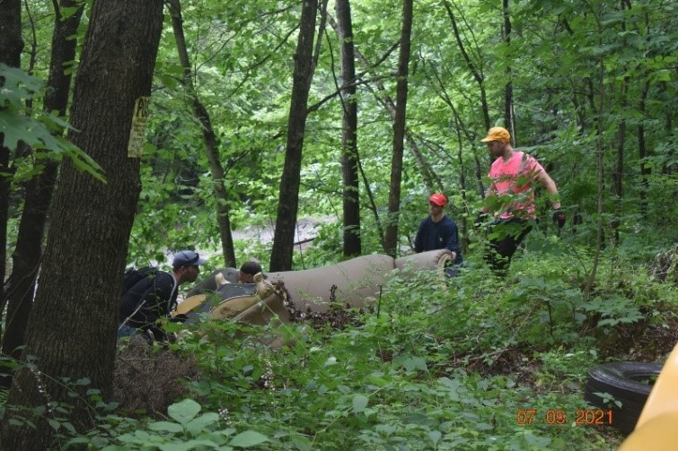 image of pulling couch from woods