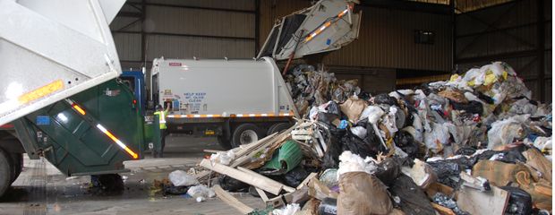 Banner of Trucks dumping garbage